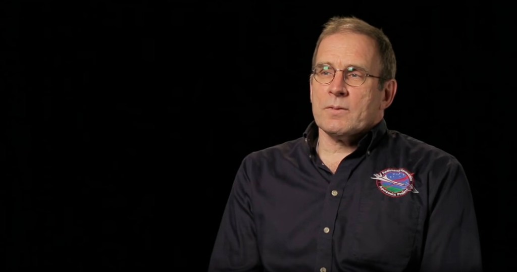 Peter Coen sitting and giving an interview on supersonic flight.