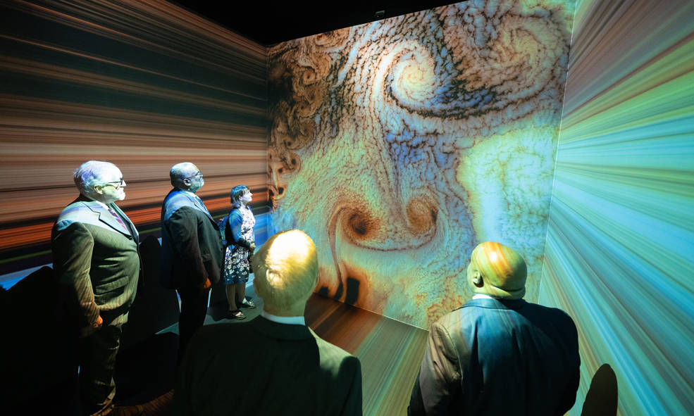 Senior federal officials watch Space for Earth, the immersive audio-visual installation in NASAs Earth Information Center