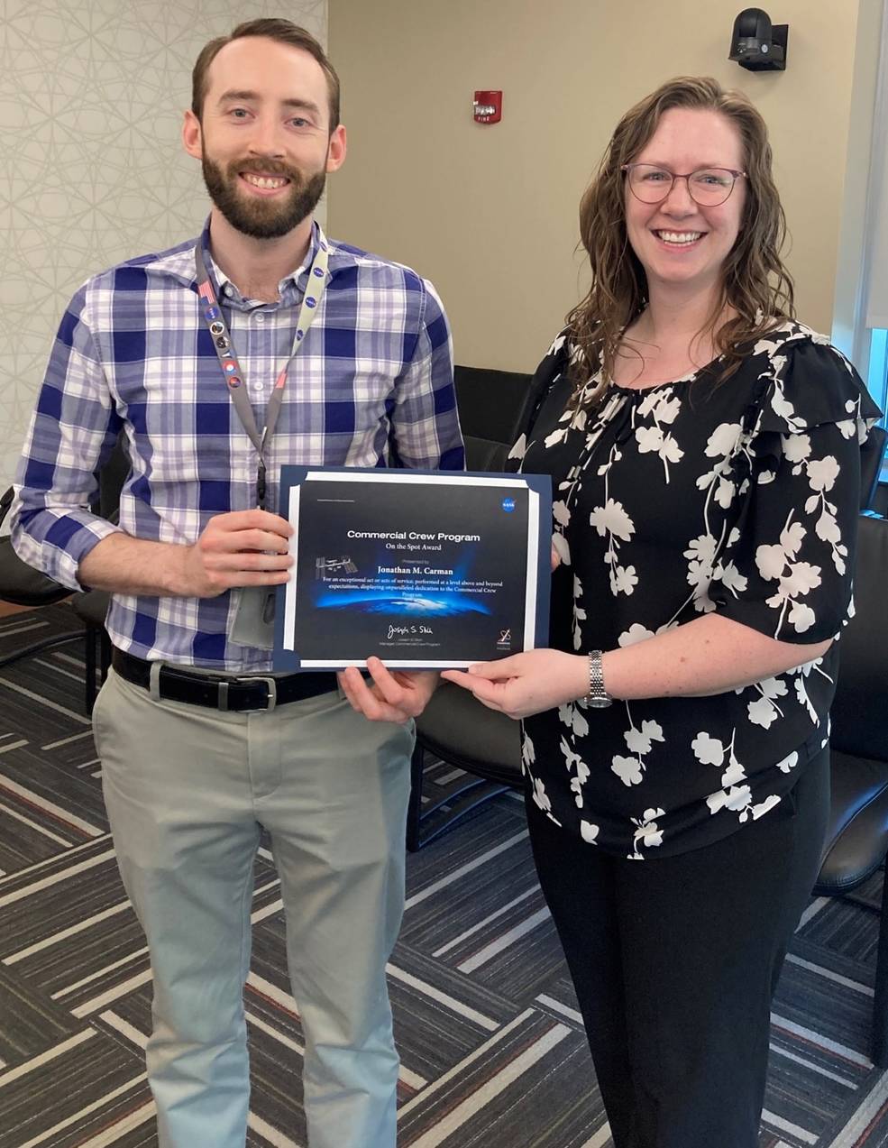 Johnathan M. Carman receives the On-the-Spot award from McCollum. He won the award along with Jarel Lawrence, who is not pictured.