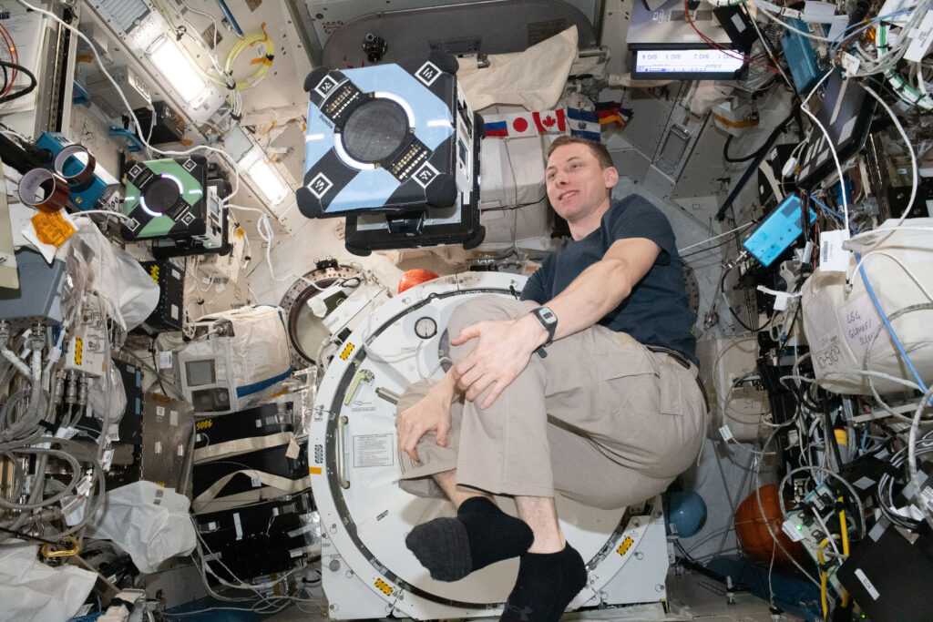 NASA astronaut and Expedition 69 Flight Engineer Woody Hoburg monitors an Astrobee robotic free-flyer in the Kibo laboratory module testing its operations in conjunction with mission controllers. The robotics work is being done to demonstrate ways to control the free-flyers using student-written code that recognizes multiple gestures.