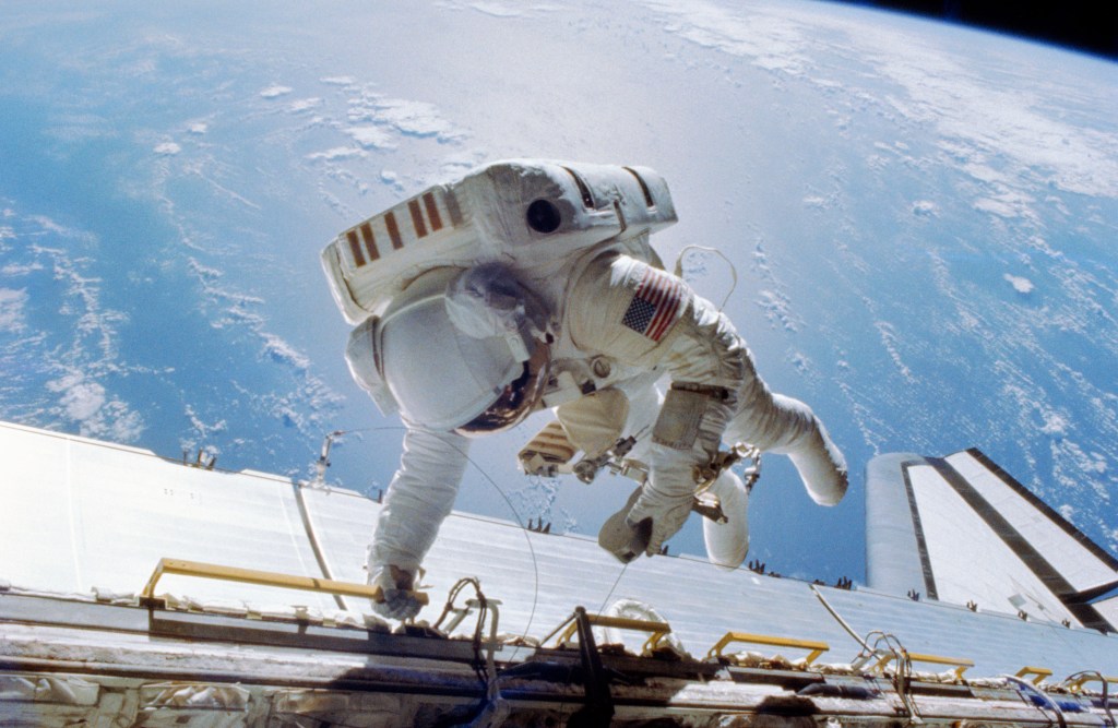 Astronaut Dale A. Gardner is tethered to Discovery's starboard side during an extravehicular activity (EVA).