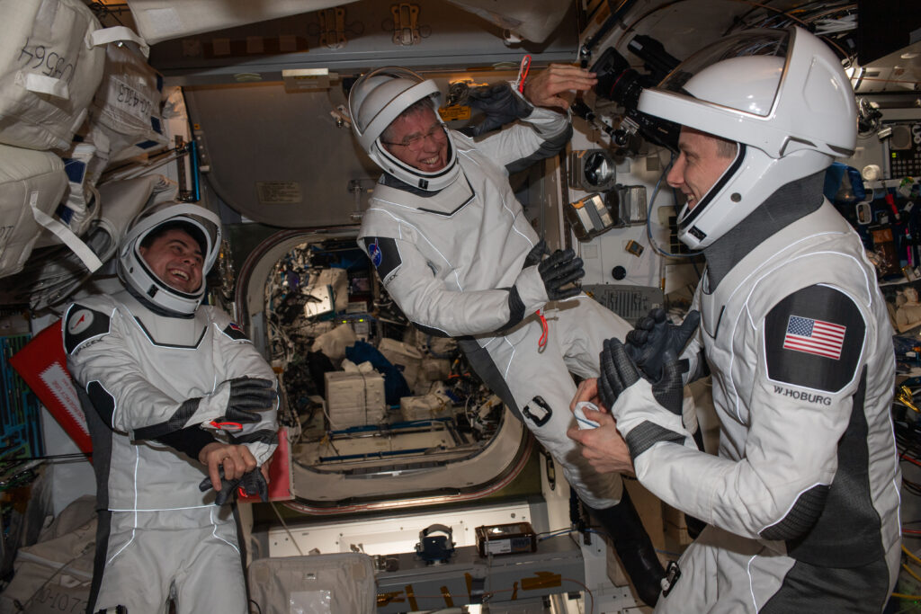 Expedition 69 Flight Engineers (from left) Andrey Fedyaev of Roscosmos and Stephen Bowen and Woody Hoburg, both from NASA, are pictured in the SpaceX pressure suits they will wear when they return to Earth aboard the company's Dragon Endeavour spacecraft in September.