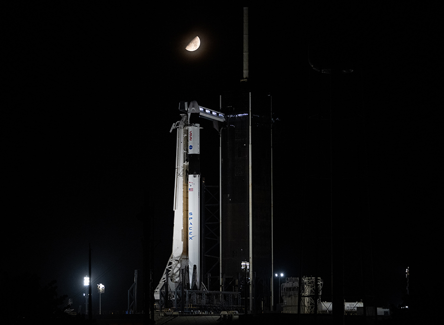 The Moon is pictured above the SpaceX Falcon 9 rocket with the Dragon Endurance spacecraft on top at NASA's Kennedy Space Center in Florida. Credit: NASA/Joel Kowsky