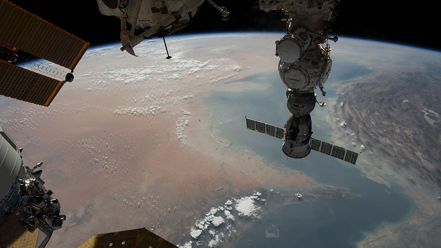 The Strait of Hormuz connects the Gulf of Oman with the Persian Gulf in this photograph from the space station. The Soyuz MS-23 crew ship (right) and a portion of the Cygnus space freighter (lower left) can also be seen.