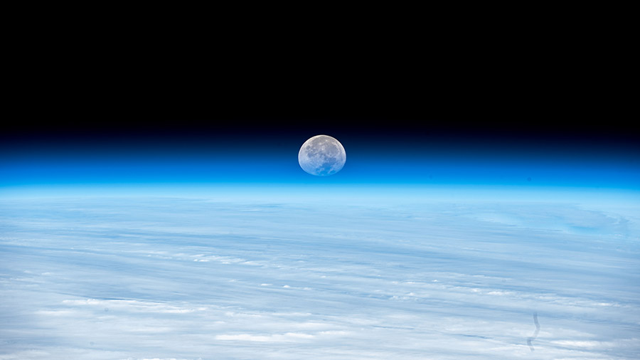 The Moon's image is refracted due to Earth's atmosphere in this photograph from the space station as it orbited above the Pacific Ocean.