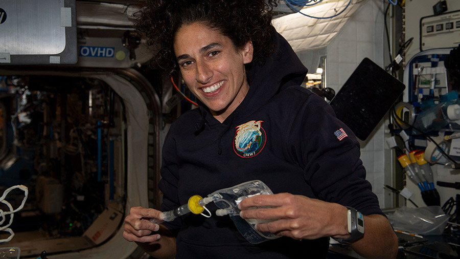 NASA astronaut Jasmin Moghbeli collects water samples for microbial analysis inside the Destiny laboratory module.