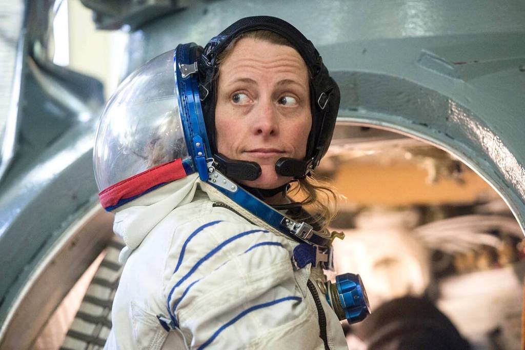 Astronaut Loral O'Hara enters a Soyuz spacecraft simulator