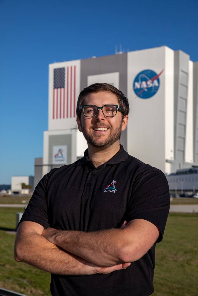 NASA Kennedy Space Center's Sean Arrieta is photographed in front of the Vehicle Assembly Building.