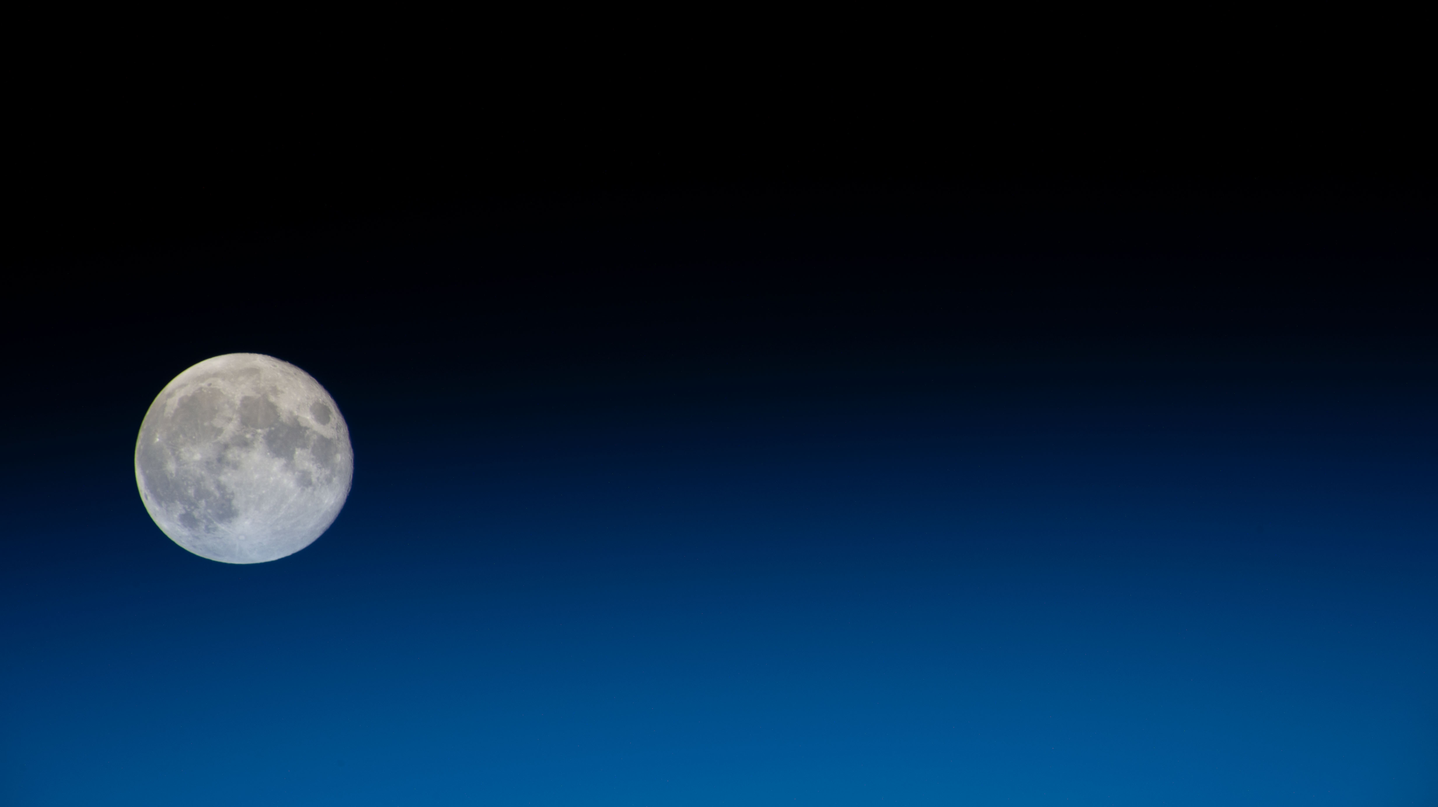 A Full Moon with Earth’s Blue Glow Beneath it