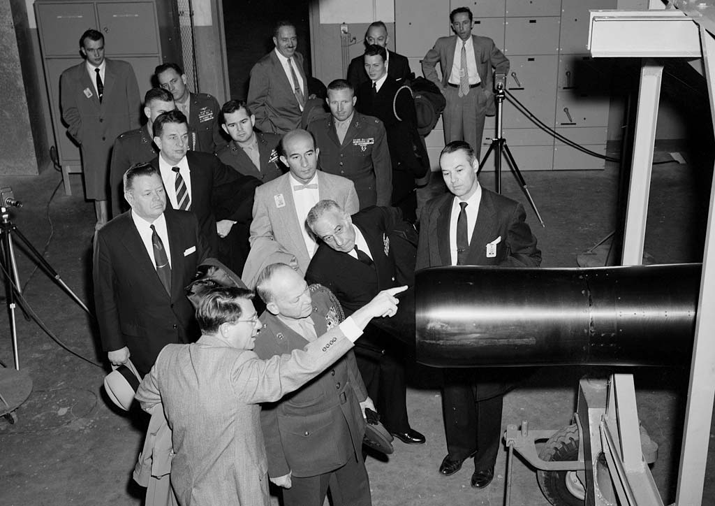 Man leading group tour of wind tunnel.