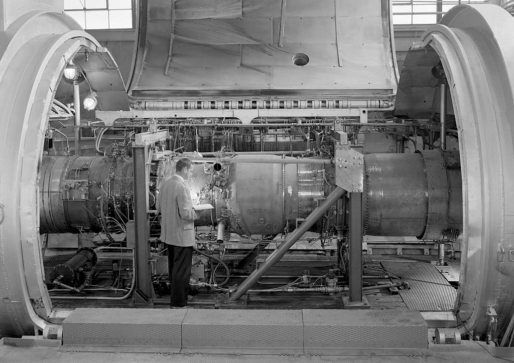 Man inspecting engine test setup.