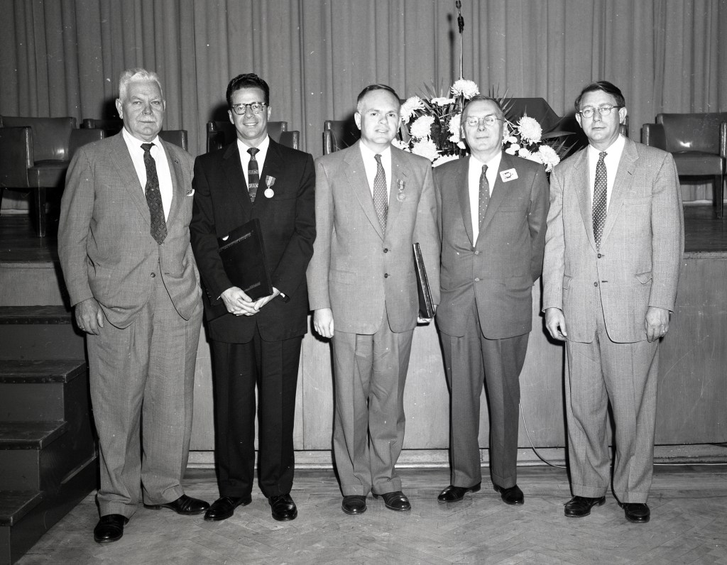 Group of men in front of stage.