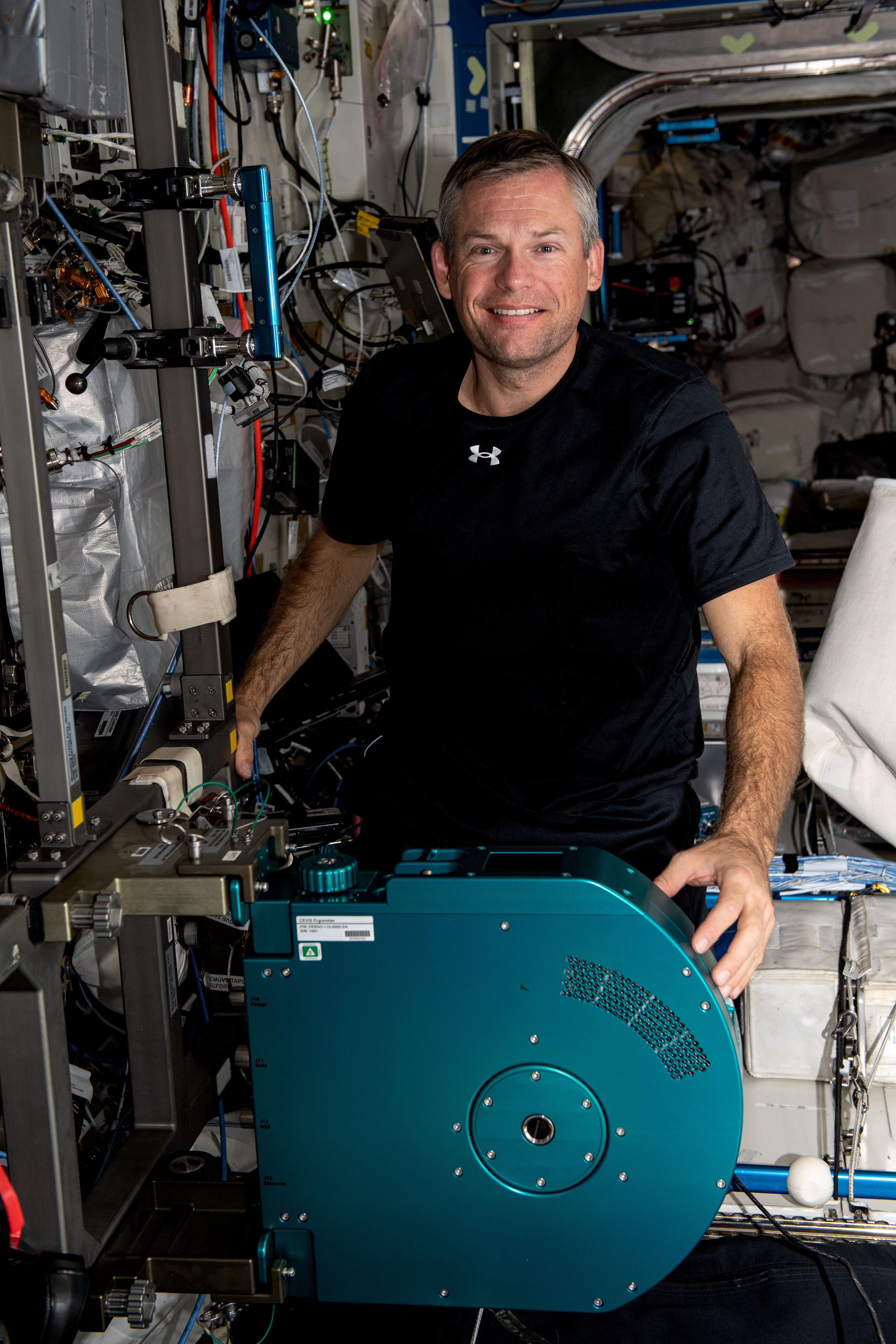 Astronaut Andreas Mogensen is pictured with a new exercise cycle
