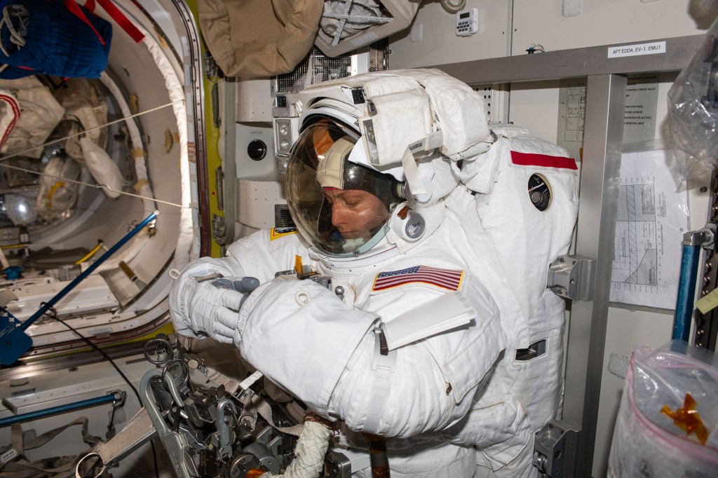 NASA astronaut and Expedition 70 Flight Engineer Loral O'Hara is pictured trying on her spacesuit and testing its components aboard the International Space Station's Quest airlock in preparation for an upcoming spacewalk.