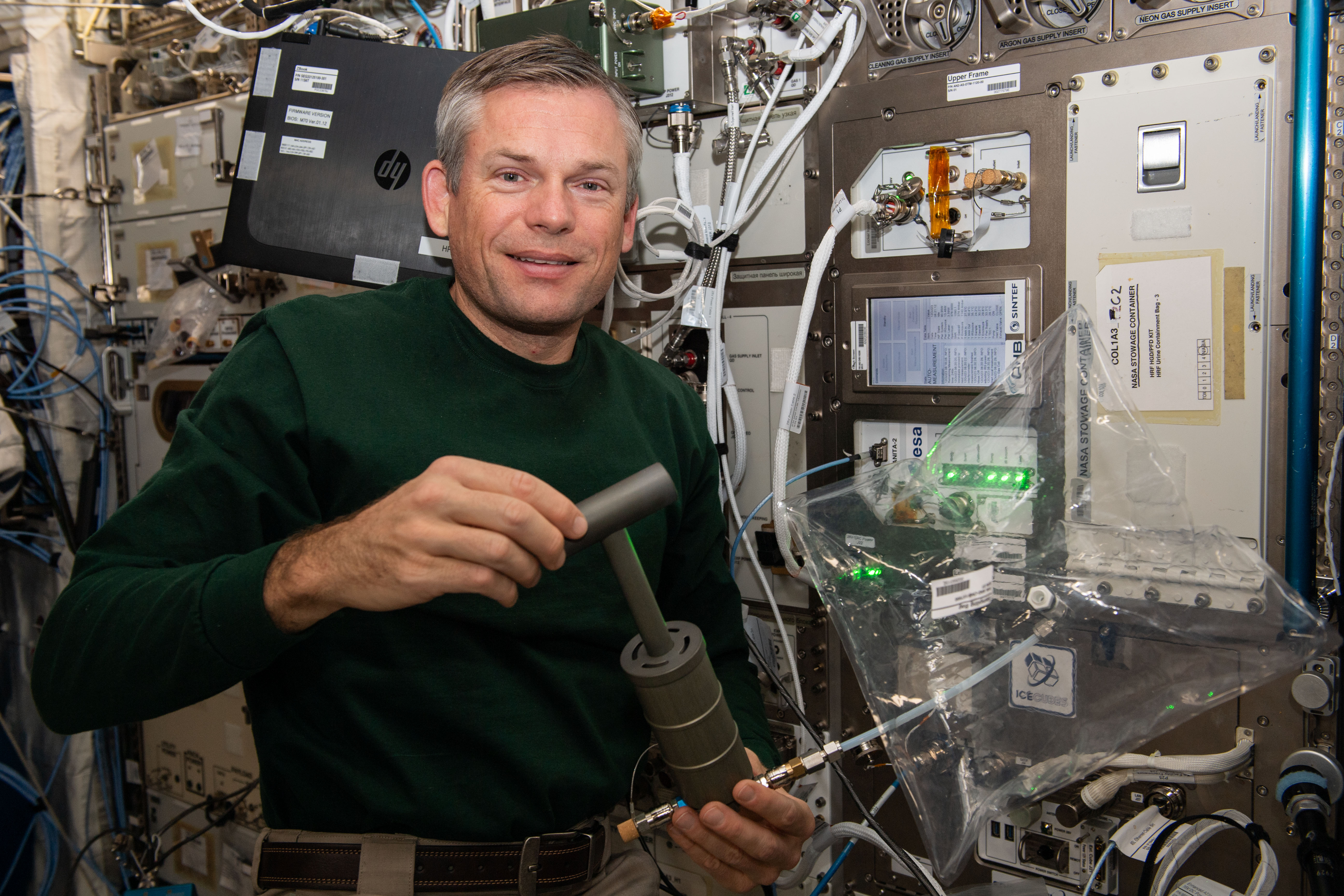 Astronaut Andreas Mogensen demonstrates collecting air samples