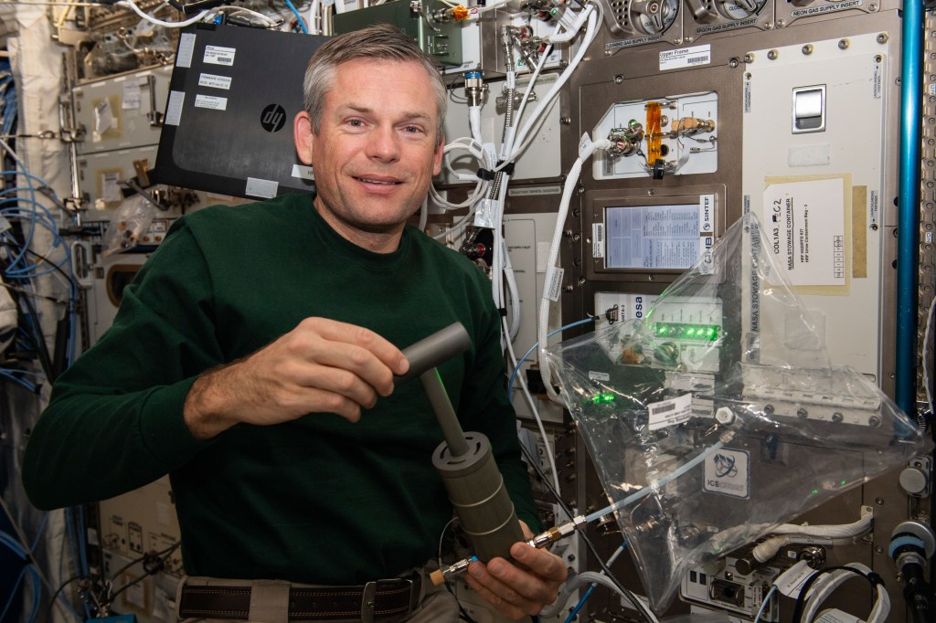 iss070e003139_alt (Oct. 12, 2023) --- Expedition 70 Commander Andreas Mogensen of ESA (European Space Agency) demonstrates collecting air samples to analyze and quantify trace contaminants in the International Space Station's atmosphere. The Analyzing Interferometer for Ambient Air-2, or ANITA-2, serves as a technology demonstration in support of human exploration missions beyond low-Earth orbit.