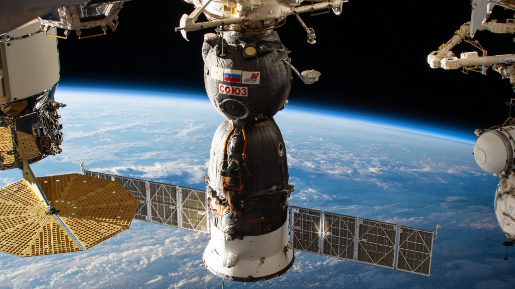 The Soyuz MS-24 crew ship is docked to the Rassvet module in this photograph from the International Space Station as it orbited 267 miles above the Tasman Sea in between Australia and New Zealand. At left, is the Northrop Grumman Cygnus space freighter and one of its prominent cymbal-shaped UltraFlex solar arrays.