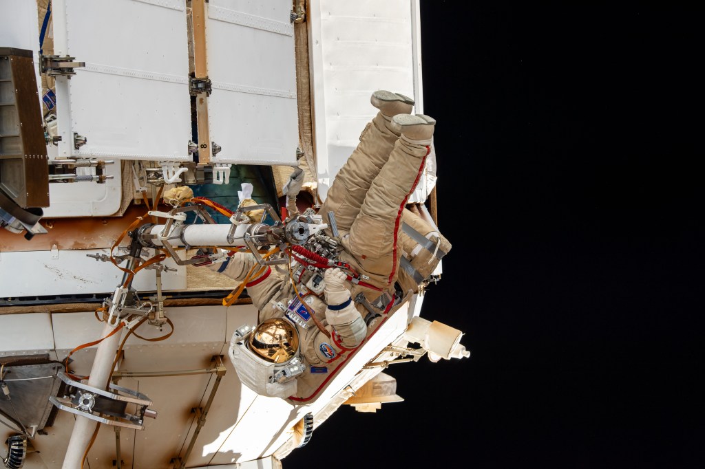 Expedition 70 Flight Engineer Oleg Kononenko from Roscosmos is pictured during a spacewalk to inspect a backup radiator, deploy a nanosatellite, and install communications hardware on the International Space Station's Nauka science module.