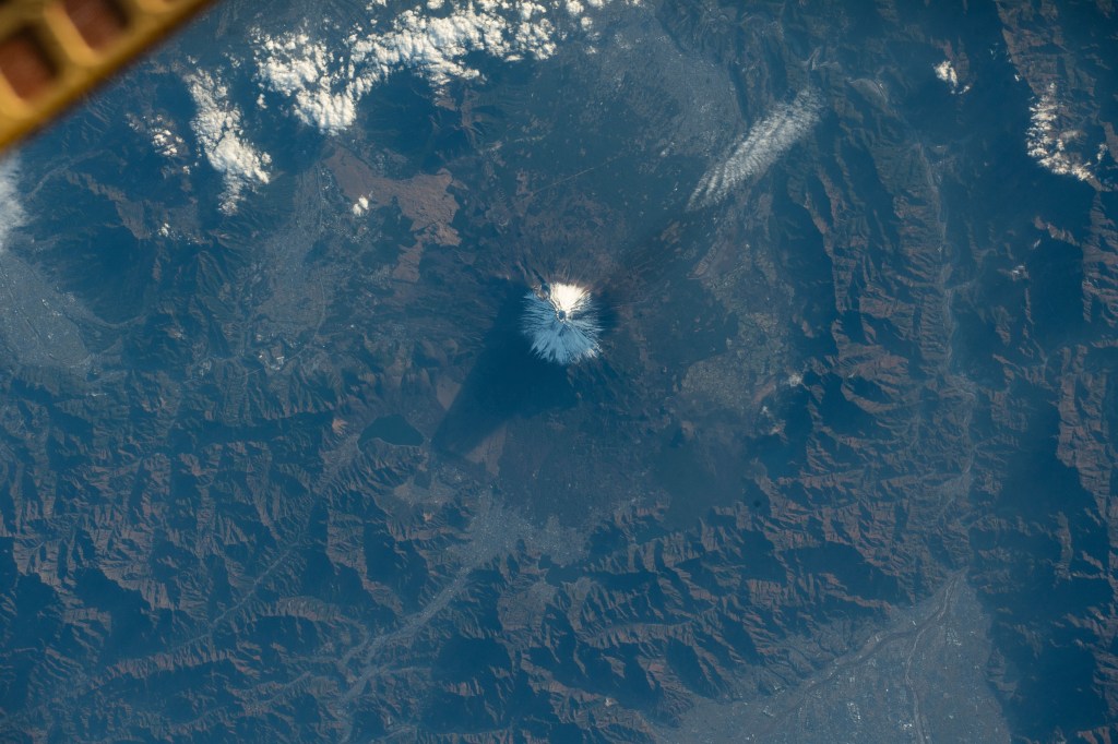 iss070e029669 (Nov. 23, 2023) -- The tallest mountain in Japan, Mount Fuji, was pictured as the International Space Station orbited 260 miles above. The summit of the active stratovolcano spends five months out of the year covered in snow, reaching over 12,000 feet (~3,700 meters) in elevation.