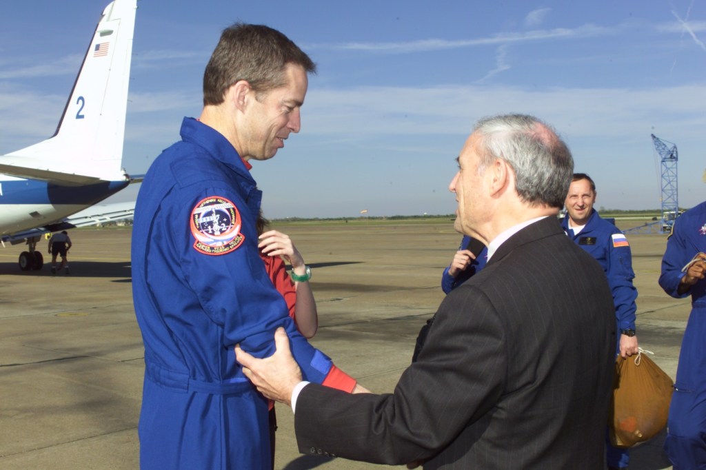 Astronaut James D. Wetherbee (left), STS-102 mission commander, is greeted by JSC Acting Director Roy S. Estess following crew arrival at Ellington Field.