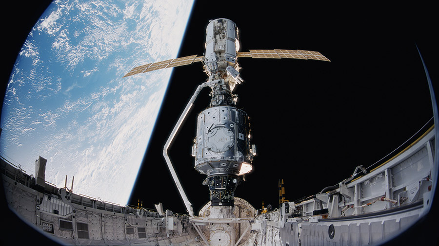 Space shuttle Endeavour's Canadarm robotic arm was used to grapple the Zarya module and connect it to the Unity module stowed in the shuttle's payload bay on Dec. 6, 1998.