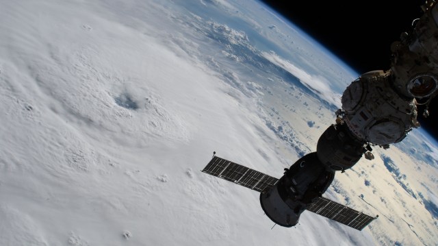 Hurricane Fiona is pictured from the International Space Station as it orbited 259 miles above the Atlantic Ocean north of Puerto Rico. In the foreground, the Soyuz MS-21 crew ship docked to the Prichal module is silhouetted above the storm.