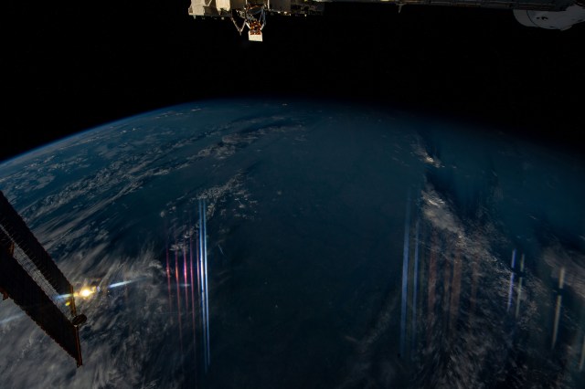 Instrumentation lights reflect off a window on the International Space Station as it orbited 260 miles above eastern Europe in this night time photograph.