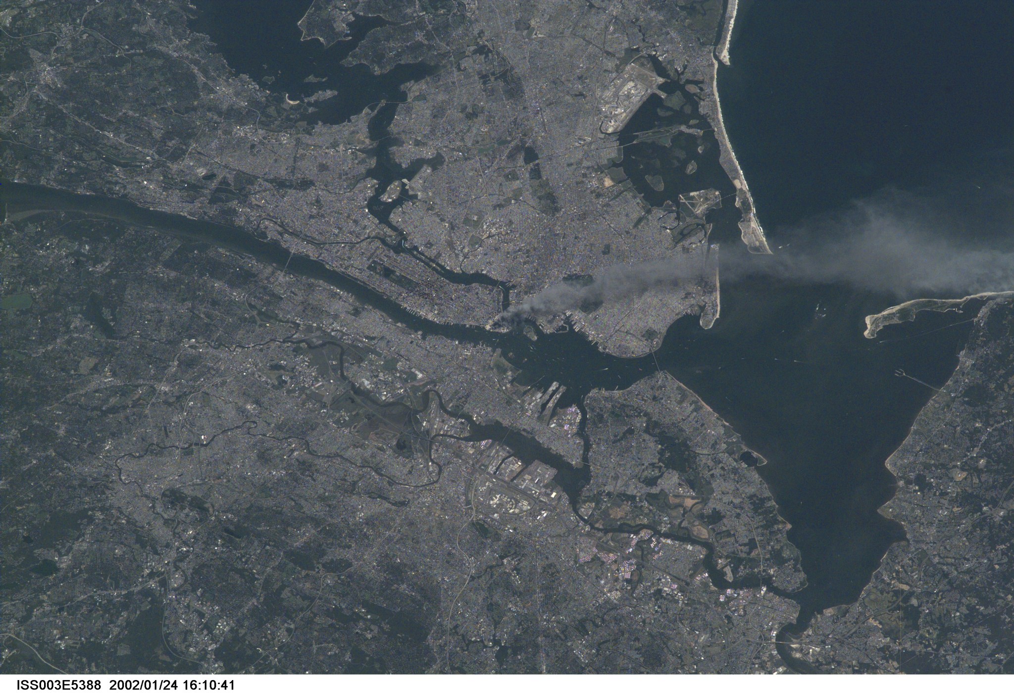 One of a series of pictures taken of metropolitan New York City (and other parts of New York as well as New Jersey) by one of the Expedition Three crew members onboard the International Space Station (ISS) at various times during the day of September 11, 2001. The image shows a smoke plume rising from the Manhattan area. The orbital outpost was flying at an altitude of approximately 250 miles. The image was recorded with a digital still camera. Please note: The date identifiers on some frames (other than those that indicate Sept. 11, 2001) are not accurate due to a technical problem with one of the Expedition Three cameras.