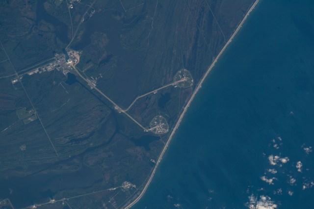 Kennedy Space Center's launch pads, 39A and 39B, are pictured on Merritt Island in Florida from the International Space Station as it orbited 259 miles above the Bahamas in the Atlantic Ocean. Launch Pad 39A (bottom) is leased by SpaceX while Launch Pad 39B is hosting the Space Launch System that will launch the Artemis I uncrewed test mission to the Moon.
