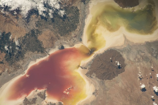 Lake Urmia in northwest Iran, once one of the biggest saltwater lakes in the world, is pictured from the International Space Station as it orbited 258 miles above. Persistent drought, dam-building, and agricultural activities contributed to the lake's depletion leading to excessive red algae growth and a soaring salt content. Restoration programs, returning rainfall, and falling water consumption over the last several years have begun to replenish the lake.