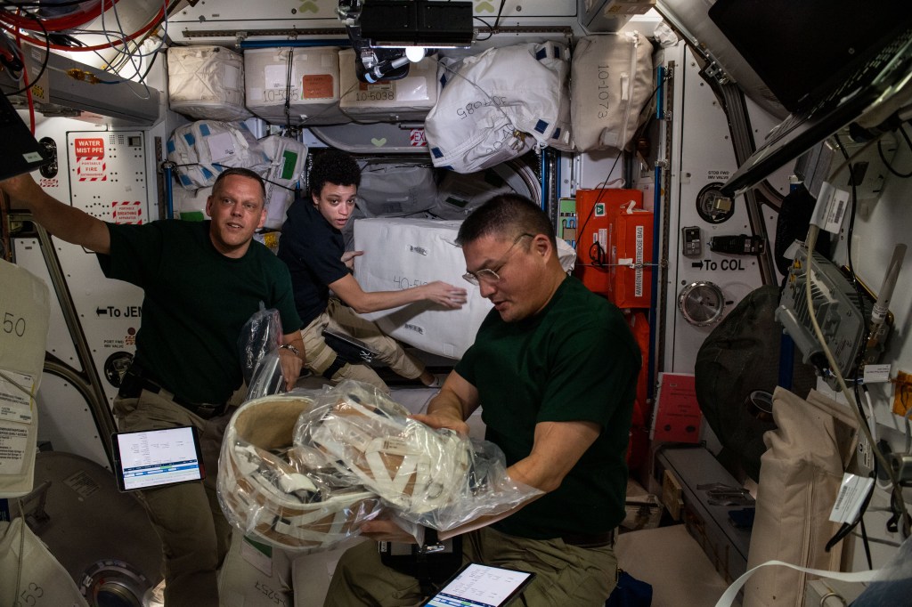 Expedition 67 Flight Engineers (from left) Bob Hines, Jessica Watkins, and Kjell Lindgren (all from NASA), unload cargo and time-critical science experiments a couple of hours after the SpaceX Dragon resupply ship docked to the Harmony module's forward port on the International Space Station.