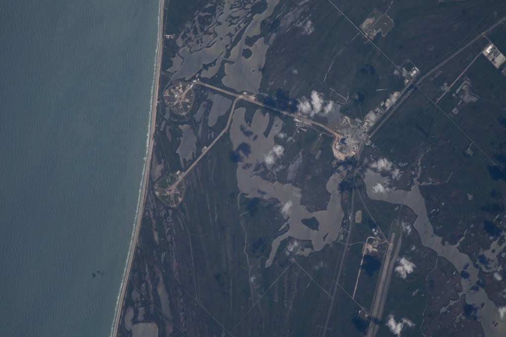 The International Space Station was orbiting just off the coast of Cape Canaveral, Florida, about 260 miles above the Atlantic Ocean when Expedition 67 Flight Engineer Raja Chari photographed NASA's Kennedy Space Center. The agency's two launch pads, 39A (at top) and 39B (at bottom), are clearly seen on the beach. Standing at launch pad 39B is NASA's Space Launch System (SLS) rocket with the Orion spacecraft atop. The rocket is being prepared for the uncrewed Artemis I mission "that will demonstrate NASA’s commitment and capacity to extend humanity’s presence on the Moon – and beyond."