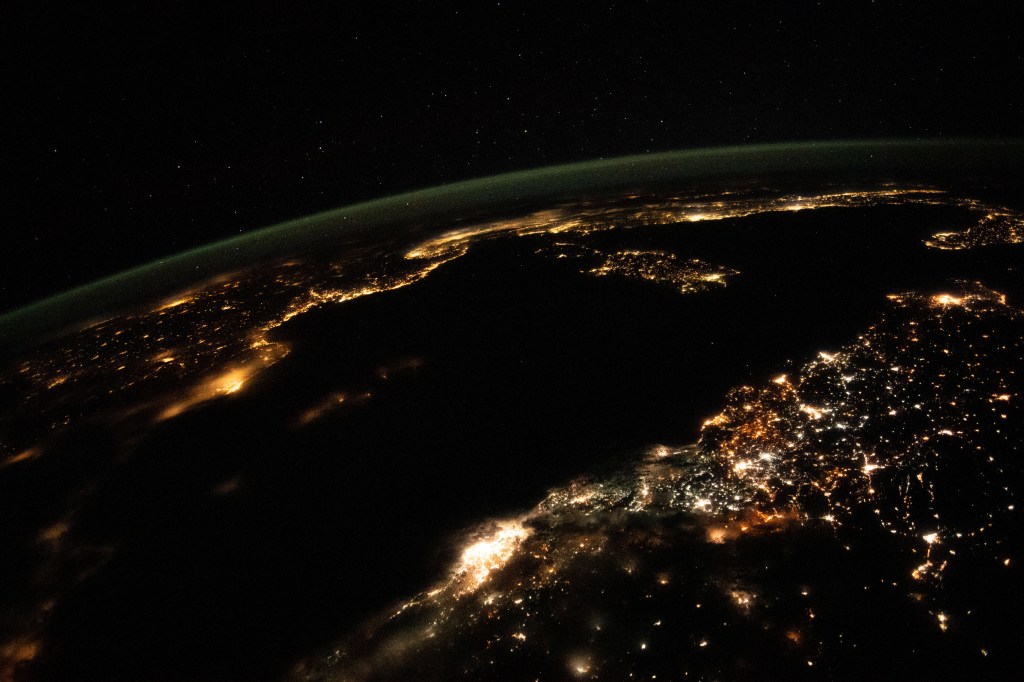 This night time photograph from the International Space Station as it orbited 261 miles above looks across the Mediterranean Sea from north Africa to southern Europe. The city lights of Algiers, Algeria, to Tunis, Tunisia, highlight Africa's northern coast from the bottom center toward upper right. From far left, the city lights of city-state Monaco to Naples, Italy, define the shores of southern Europe. The French island of Corsica and the Italian island of Sardinia are also pictured.