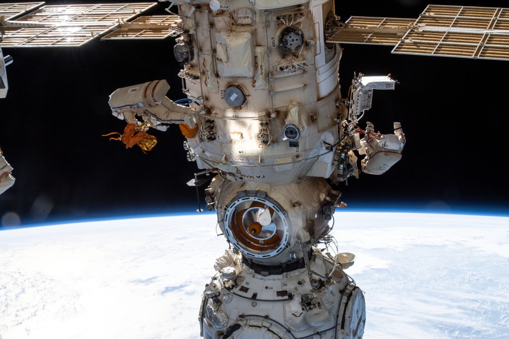 Two spacewalkers from Roscosmos are pictured on either side of the Nauka multipurpose laboratory module as the International Space Station orbited 263 miles above the Atlantic Ocean off the coast of Angola. Cosmonauts (from left) Denis Matveev and Oleg Artemyev worked outside the station's Russian segment for six hours and 37 minutes outfitting Nauka and configuring the European robotic arm.