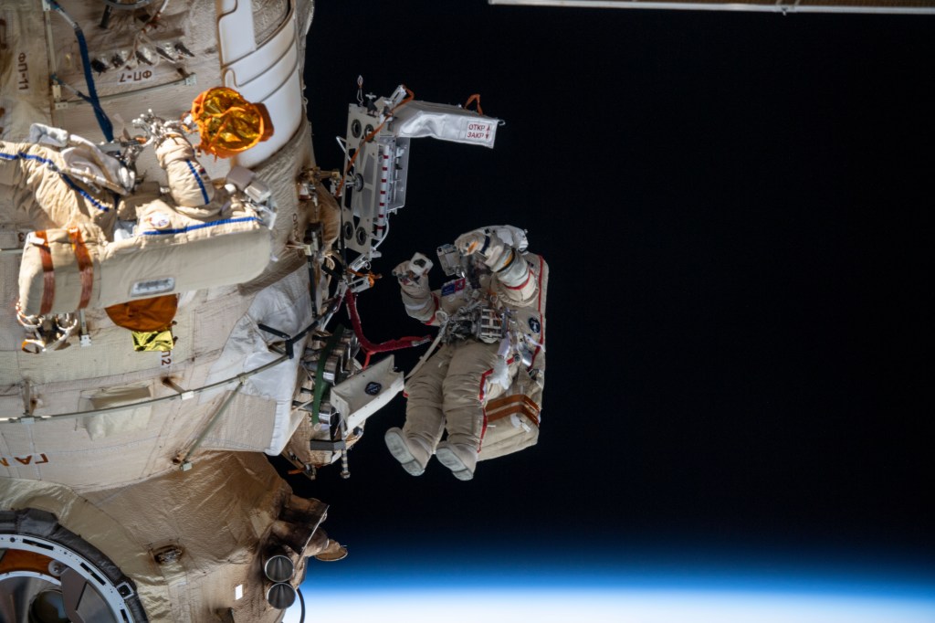 Two spacewalkers from Roscosmos are pictured working outside the Nauka multipurpose laboratory module as the Intermtional Space Station orbited 261 miles above the Gulf of St. Lawrence off the coast of Îsles de la Madeleine. Cosmonauts (from left) Denis Matveev and Oleg Artemyev worked outside the station's Russian segment for six hours and 37 minutes outfitting Nauka and configuring the European robotic arm.