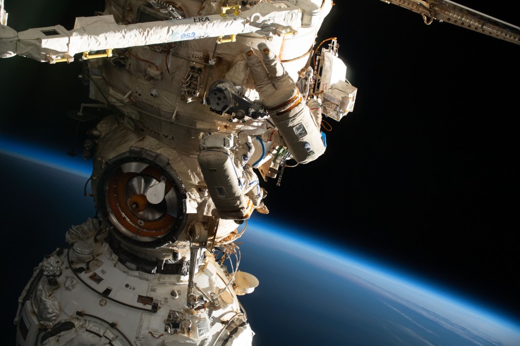 (From bottom to top) Spacewalkers Samantha Cristoforetti of ESA (European Space Agency) and Oleg Artemyev of Roscosmos work outside the Nauka multipurpose laboratory module on the International Space Station while wearing Russian Orlan spacesuits. The duo continued the outfitting of the European robotic arm attached to Nauka during the spacewalk that lasted seven hours and five minutes.