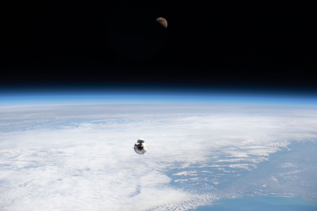 The SpaceX Dragon Endeavour carrying four Axiom Mission 1 astronauts approaches the International Space Station less than a day after launching from NASA's Kennedy Space Center in Florida. Pictured above Earth's horizon is the first quarter Moon.