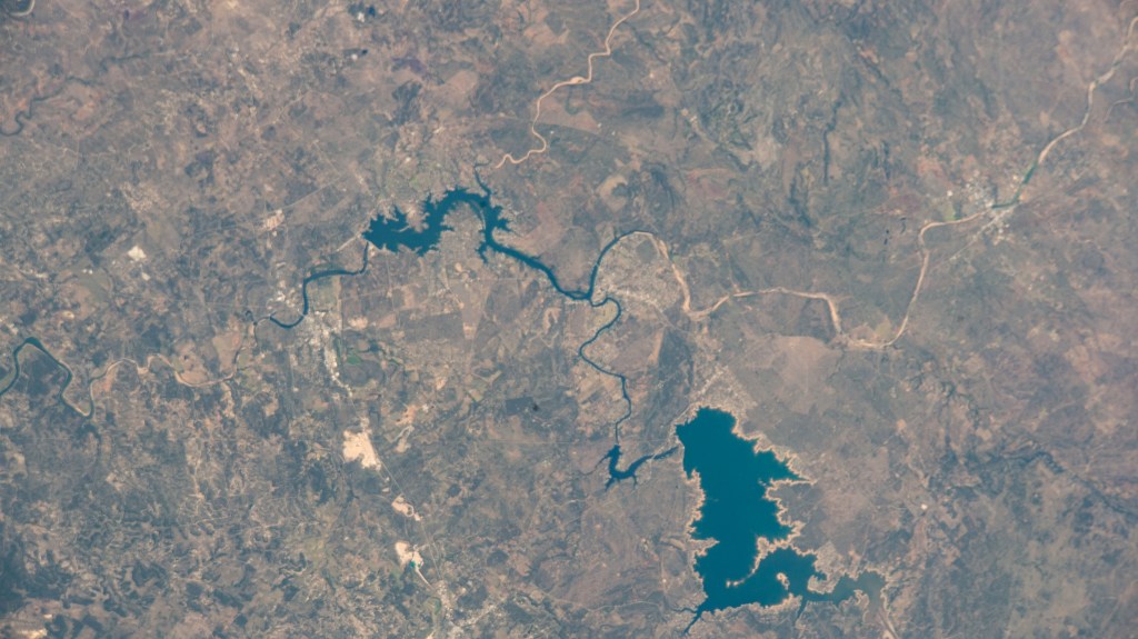 The Colorado River leads to Lake Buchanan (lower right) formed by the Buchanan Dam that provides water supply and hydroelectric power in Texas. The International Space Station was orbiting 262 miles above the Lone Star state at the time of this photograph.