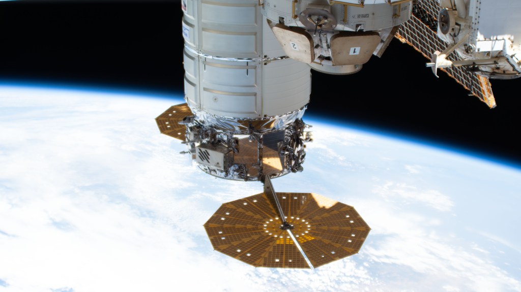 The Cygnus space freighter from Northrop Grumman, with its prominent cymbal-shaped solar arrays, is pictured attached to the International Space Station's Unity module as the orbiting lab flew 263 miles above the coast of Lisbon, Portugal.