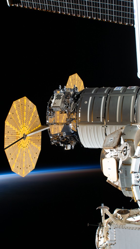 Northrop Grumman's Cygnus space freighter is pictured attached to the International Space Station's Unity module as the orbiting lab flew 268 miles above the south Atlantic into an orbital sunset.