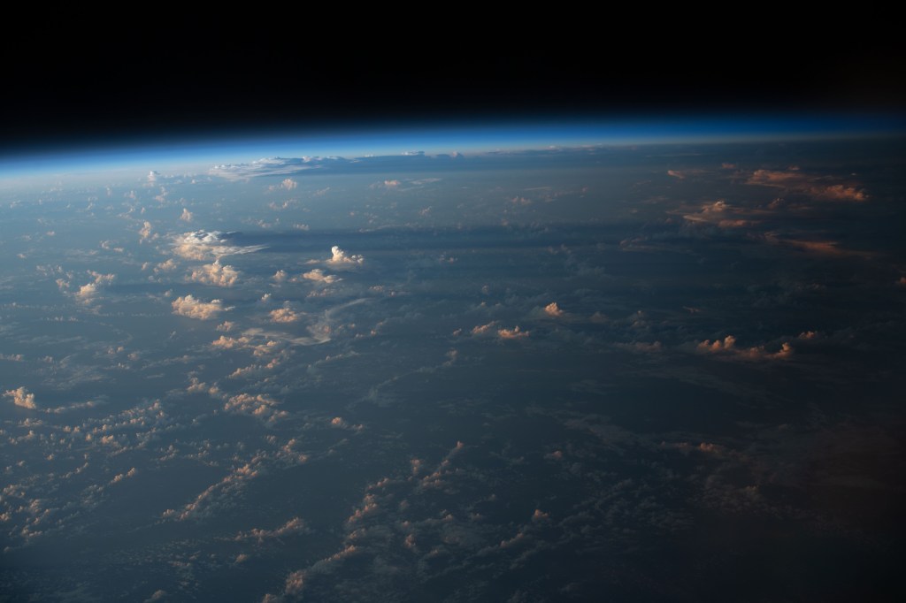 iss068e022267 (Nov. 13, 2022) --- Cloud shadows stretch across the Earth during an orbital sunset as the International Space Station soared 258 miles above the Atlantic coast of Suriname in South America.