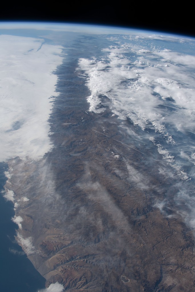 iss068e022209 (Nov. 13, 2022) --- Clouds gather near the peaks of the Andes Mountain range in Peru in this photograph from the International Space Station as it orbited 262 miles above the South American nation's Pacific coast.