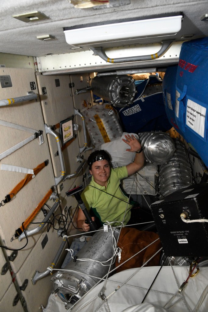iss068e029372 (Dec. 12, 2022) --- Roscosmos cosmonaut and Expedition 68 Flight Engineer Anna Kikina is pictured inside the International Space Station's Zarya module conducting cleaning activities.
