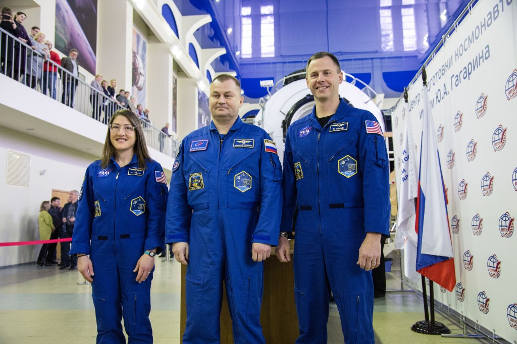 At the Gagarin Cosmonaut Training Center in Star City, Russia, Expedition 59 crew members Christina Koch of NASA (left), Alexey Ovchinin of Roscosmos (center) and Nick Hague of NASA (right) pose for pictures Feb. 19 during the first of two days of final pre-launch qualification exams. They will launch March 14, U.S. time, from the Baikonur Cosmodrome in Kazakhstan on the Soyuz MS-12 spacecraft for a six-and-a-half month mission on the International Space Station.