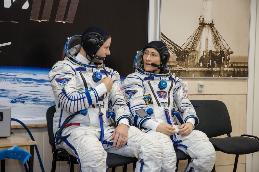 At the Baikonur Cosmodrome in Kazakhstan, Expedition 59 crew members Nick Hague (left) and Christina Koch (right) of NASA discuss procedures Feb. 27 during a Soyuz fit check dress rehearsal that is part of pre-launch training. Hague, Koch and Alexey Ovchinin of Roscosmos will launch March 14, U.S. time, on the Soyuz MS-12 spacecraft from the Baikonur Cosmodrome in Kazakhstan for a six-and-a-half month mission on the International Space Station.