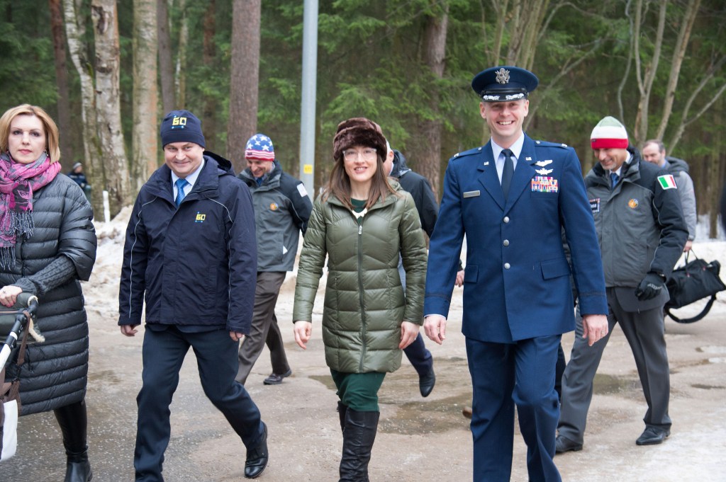 At the Gagarin Cosmonaut Training Center in Star City, Russia, Expedition 59 crew members Alexey Ovchinin of Roscosmos (second from left), Christina Koch of NASA (second from right) and Nick Hague of NASA (right) walk to a bus Feb. 26 to take them to their plane for a flight to their launch site at the Baikonur Cosmodrome in Kazakhstan for final pre-launch training. They will launch on March 14, U.S. time, on the Soyuz MS-12 spacecraft from the Baikonur Cosmodrome in Kazakhstan for a six-and-a-half month mission on the International Space Station.