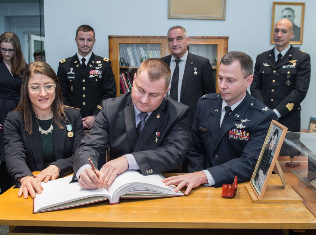 At the Gagarin Museum in the Gagarin Cosmonaut Training Center in Star City, Russia, Expedition 59 crew members Christina Koch of NASA (front, left), Alexey Ovchinin of Roscosmos (front, center) and Nick Hague of NASA (front, right) sign a ceremonial book Feb. 21 as part of their pre-launch activities as their backups in the back row, Drew Morgan of NASA, Alexander Skvortsov of Roscosmos and Luca Parmitano of the European Space Agency look on. Koch, Hague and Ovchinin will launch March 14, U.S. time, on the Soyuz MS-12 spacecraft from the Baikonur Cosmodrome in Kazakhstan for a six-and-a-half month mission on the International Space Station.