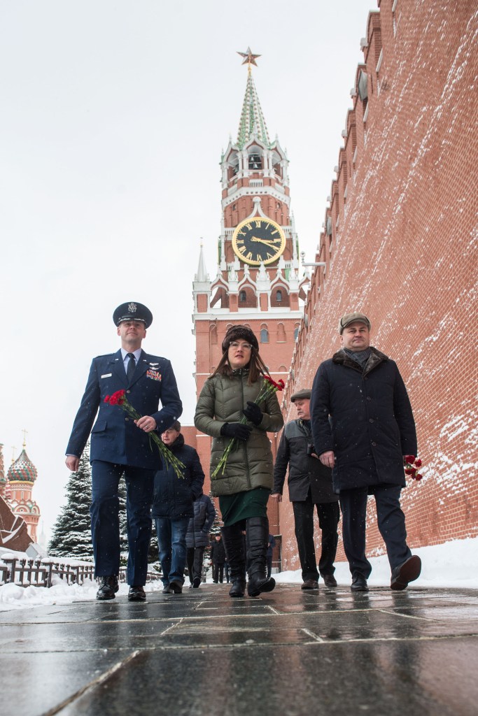 Expedition 59 crew members Nick Hague of NASA (left), Christina Koch of NASA (center) and Alexey Ovchinin of Roscosmos (right) walk along the Kremlin Wall in Moscow Feb. 21 as they prepare for the ceremonial laying of flowers as part of pre-launch activities. They will launch March 14, U.S. time, on the Soyuz MS-12 spacecraft from the Baikonur Cosmodrome in Kazakhstan for a six-and-a-half month mission on the International Space Station.