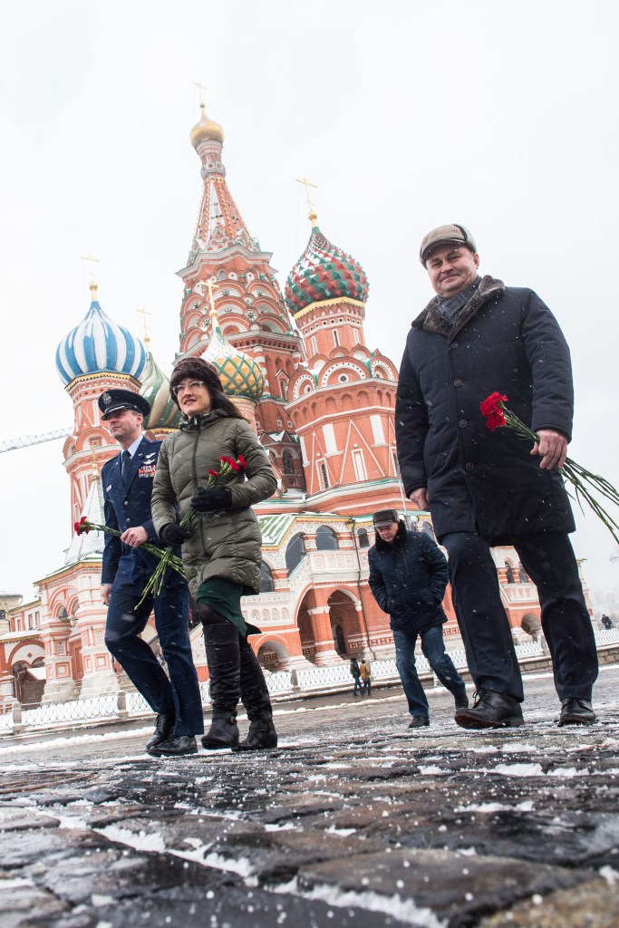 With St. Basil’s Cathedral in Red Square in Moscow providing a wintry backdrop, Expedition 59 crew members Nick Hague of NASA (left), Christina Koch of NASA (center) and Alexey Ovchinin of Roscosmos (right) walk toward the Kremlin Wall Feb. 21 prior to the ceremonial laying of flowers. They will launch March 14, U.S. time, on the Soyuz MS-12 spacecraft from the Baikonur Cosmodrome in Kazakhstan for a six-and-a-half month mission on the International Space Station.