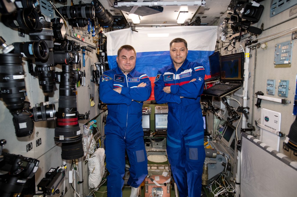 Expedition 59 Flight Engineer Alexey Ovchinin (left) and Commander Oleg Kononenko, both Roscosmos cosmonauts, are pictured inside the International Space Station's Zvezda service module.